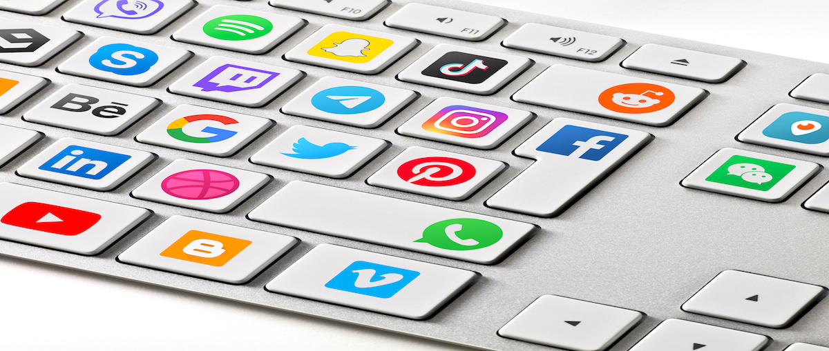 Social media are trending and both business as consumer are using it for information sharing and networking. Showing social media icons on a keyboard.